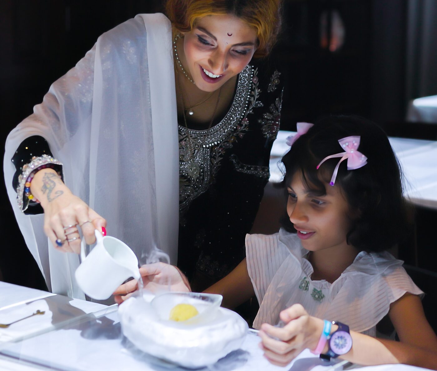 A family enjoying the Le Petit Chef dinner experience